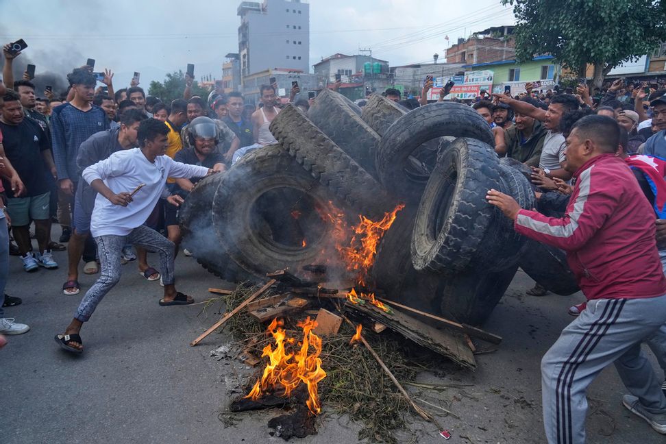 Demonstranter tänder eld på däck i Katmandu på tisdagen. Foto: Niranjan Shrestha/AP/TT