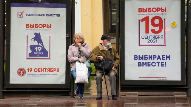 In this Sept. 8, 2021, file photo, people sit at a bus stop decorated with posters ahead of the election to the State Duma, the lower house of parliament, and the local legislature in St. Petersburg, Russia. There will be three days of voting this weekend, ending on Sunday, Sept. 19, for the new parliament that is unlikely to change the country’s political complexion. Photo: Dmitri Lovetsky/AP/TT