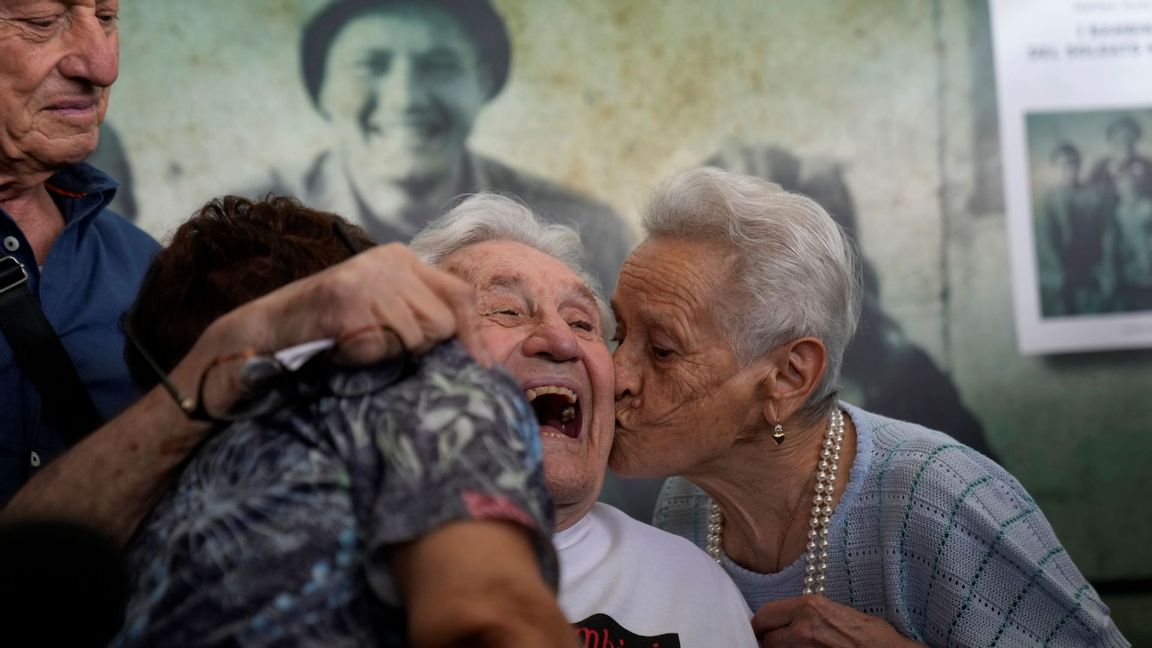 Martin Adler, a 97-year-old retired American soldier, center, receives a kiss from Mafalda, right, and Giuliana Naldi, whom he saved during WWII, during a reunion at Bologna’s airport, in Italy, Monday, Aug. 23, 2021. For more than seven decades, Adler treasured a black-and-white photo of himself as a young soldier with a broad smile with three impeccably dressed Italian children he is credited with saving as the Nazis retreated northward in 1944. The veteran met the three siblings - now octogenarians themselves - in person for the first time on Monday, eight months after a video reunion. Photo: Antonio Calanni/AP/TT