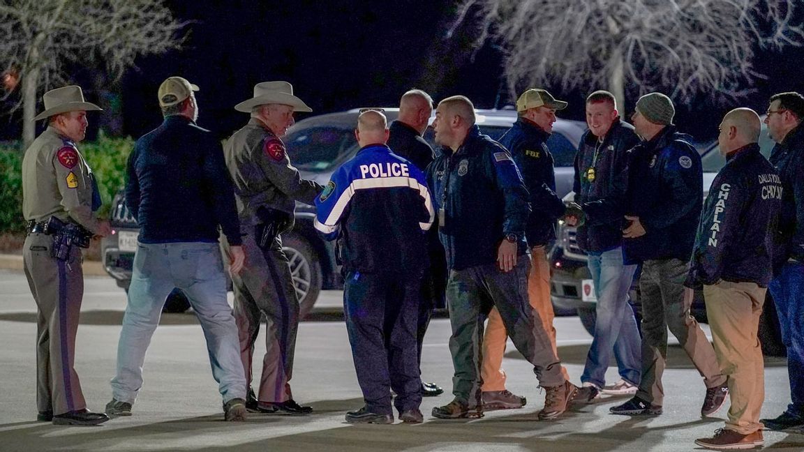 Poliser i samspråk sedan man hållit en pressträff och meddelat att samtliga av gisslan i synagogan var fria och oskadda. Foto: Tony Gutierrez/AP