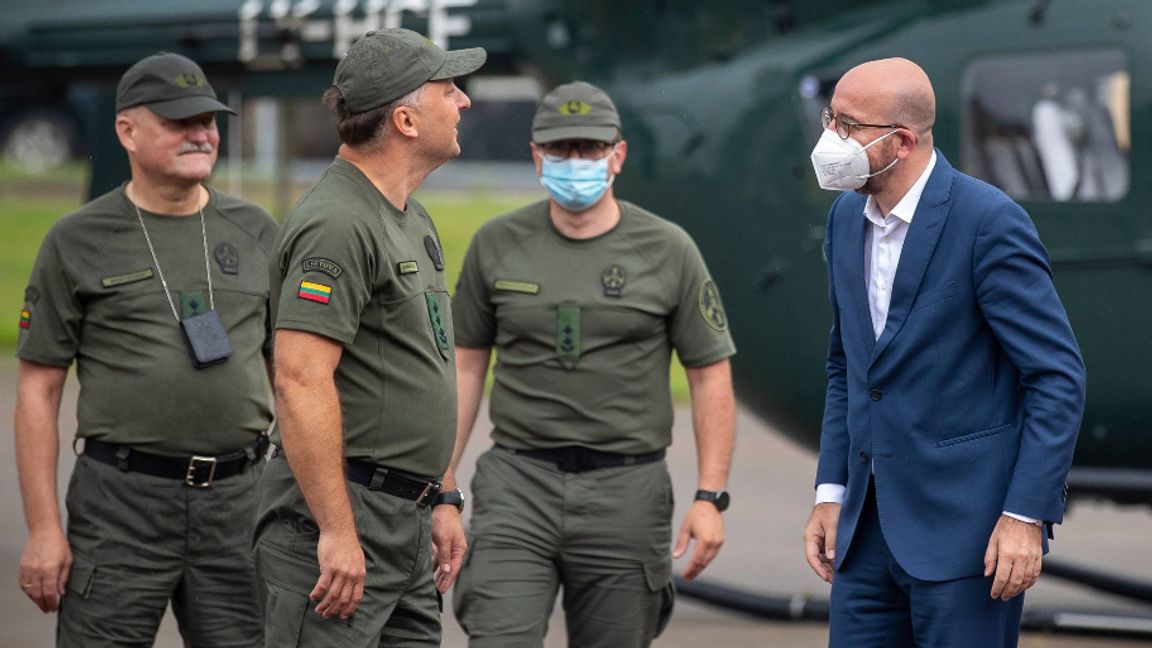 Europeiska rådets ordförande Charles Michel samtalar med litauiska gränsvakter vid ett besök i närheten av gränsen mot Belarus i tisdags. Foto: Mindaugas Kulbis/AP/TT.