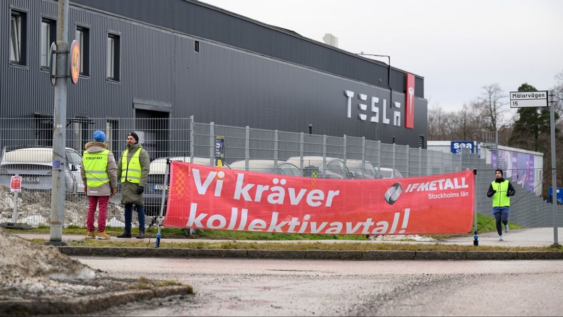 Strejkvakter utanför Tesla. En joggare passerar förbi. Joggaren verkar vara den som har energi. Foto: Jessica Gow/TT