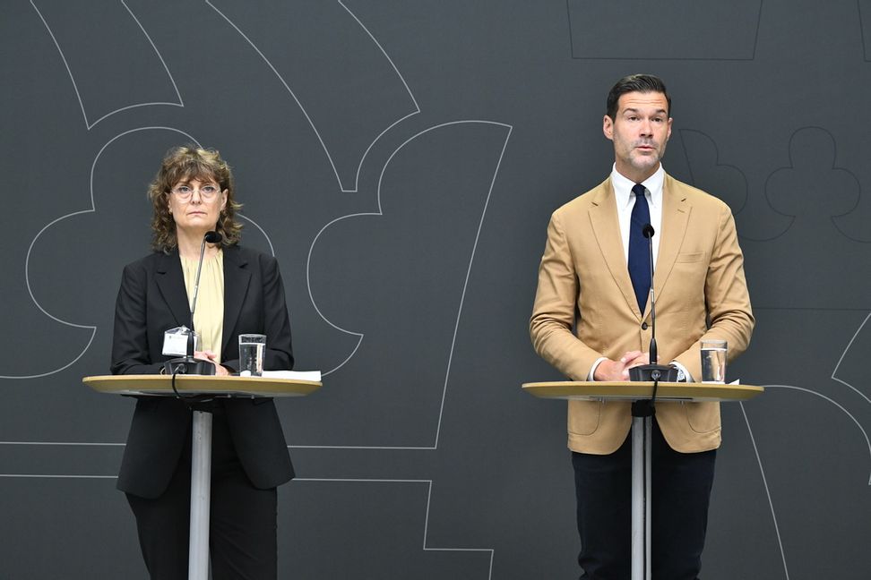 Migrationsminister Johan Forssell (M) tar emot betänkande från utredningen om skärpta villkor för anhöriginvandring, under en pressträff tillsammans med utredaren Ingrid Utne. Foto: Lars Schröder/TT