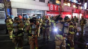 Brandmän har samlats utanför den brinnande byggnaden i Seongnam på fredagen. Foto: AP/TT