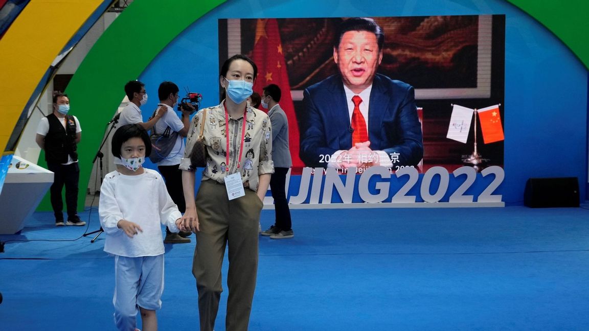 A woman and child wearing masks pass by a screen displaying Chinese President Xi Jinping during the China International Fair for Trade in Services (CIFTIS) in Beijing Sunday, Sept. 5, 2021. An avalanche of changes launched by China’s ruling Communist Party has jolted everyone from tech billionaires to school kids. Photo: Ng Han Guan/AP/TT