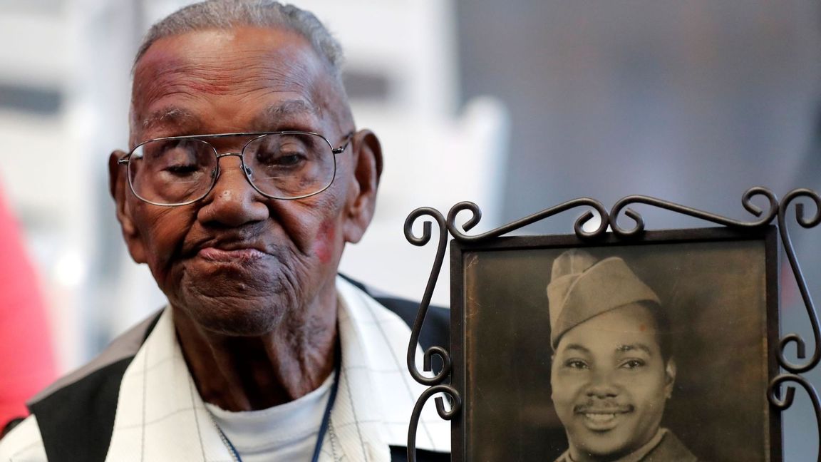 In this Sept. 12, 2019 file photo, World War II veteran Lawrence Brooks holds a photo of him taken in 1943, as he celebrates his 110th birthday at the National World War II Museum in New Orleans. Brooks celebrated his 112th birthday, Sunday, Sept. 12, 2021 with a drive-by party at his New Orleans home hosted by the National War War II Museum. Photo: Gerald Herbert/AP/TT