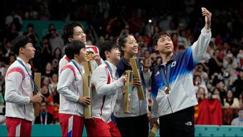 Ri Jong Sik och Kim Kum Yong (längst till vänster) deltog i en selfie med kinesiska och sydkoreanska tävlande under OS i Paris. Foto: Petros Giannakouris/AP/TT