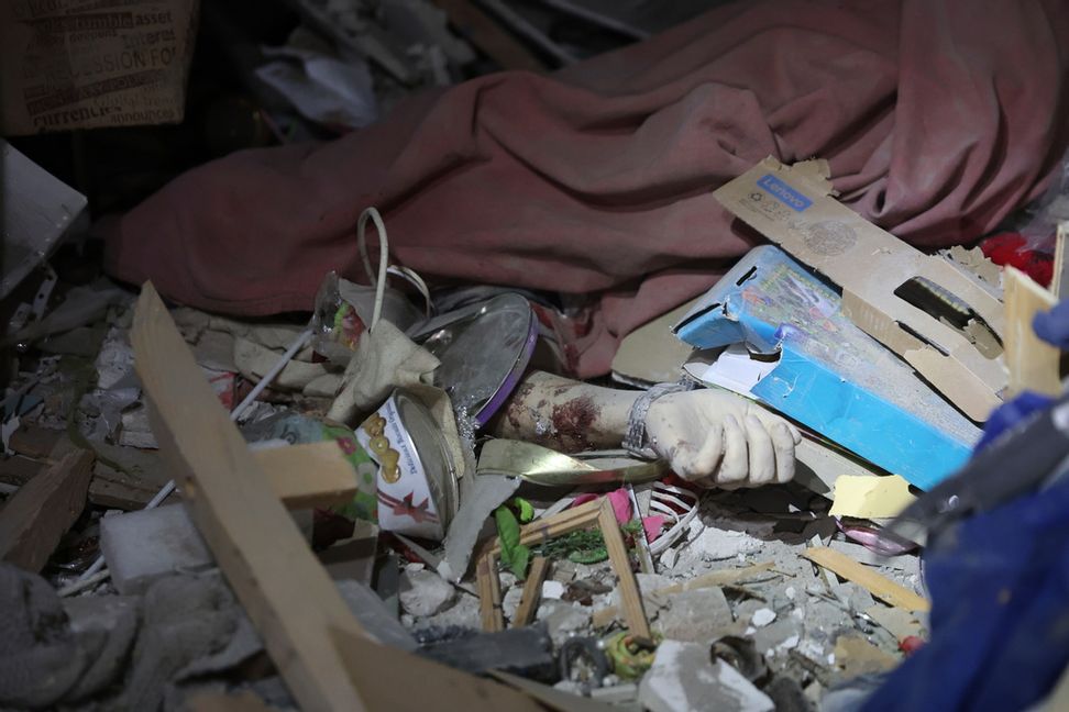 En hand tillhörande ett offer för attacken mot Zaporizjzja sticker upp ur bråte. Kateryna Klochko/AP/TT