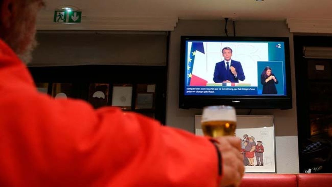 En man ser Macrons tv-tal på en bar i Baoynne i sydvästra Frankrike. Foto: Bob Edme/AP/TT