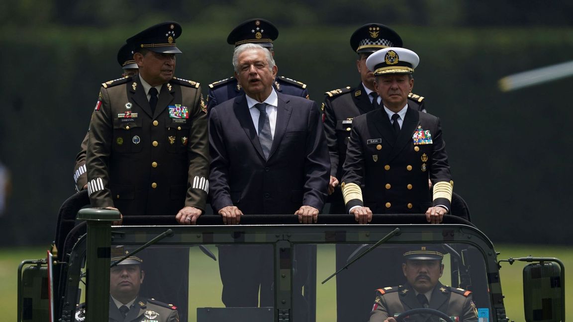 Mexico’s President Andres Manuel Lopez Obrador, center, Defense Minister Luis Cresencio Sandoval, left, and Naval Commander, Jose Rafael Ojeda, ride in a military vehicle during a parade introducing the new army commander, in Mexico City, Friday, Aug. 13, 2021. On Friday Sandoval said  that the main goal of the deployment of the army, navy and National Guard is to “stop all migration.” Photo: Fernando Llano/AP/TT