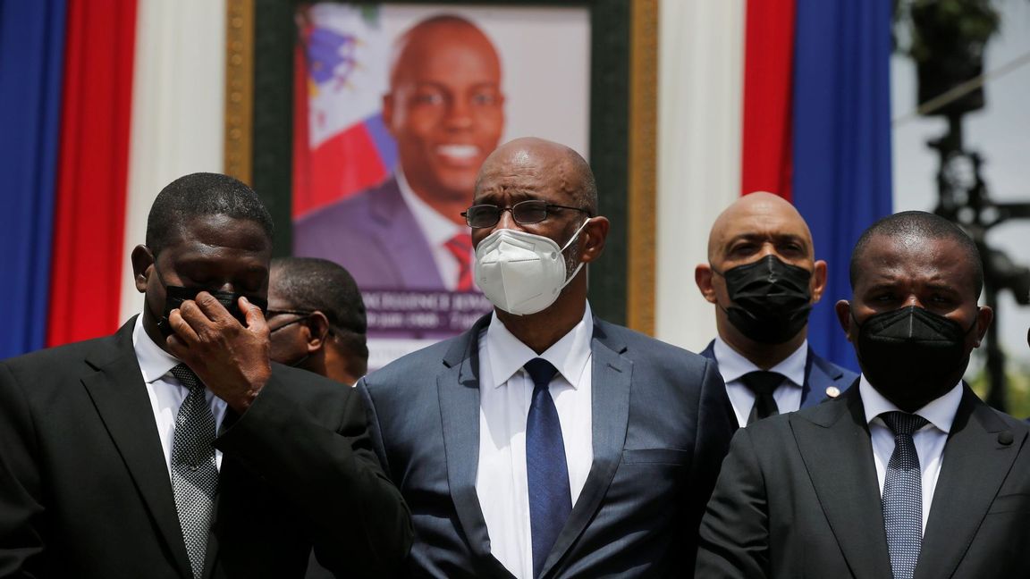 In this July 20, 2021 file photo, Haiti’s designated Prime Minister Ariel Henry, center, and interim Prime Minister Claude Joseph, right, pose for a group photo with other authorities in front of a portrait of slain Haitian President Jovenel Moise at the National Pantheon Museum during a memorial service for Moise in Port-au-Prince, Haiti. Haiti’s chief prosecutor has asked a judge to charge Henry in the slaying of his predecessor and barred him from leaving the country. Photo: Joseph Odelyn/AP/TT