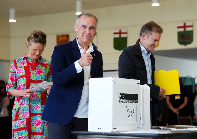Mark Carney, mitten, röstade tillsammans med sin fru Diana Fox Carney i Ottawa. Foto: Sean Kilpatrick/AP/TT