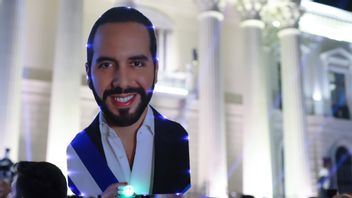 En anhängare till president Nayib Bukele håller upp ett utskuret foto av honom i San Salvador på söndagskvällen. Foto: Salvador Melendez/AP/TT