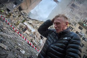 En pappa vars son saknas i rasmassor gråter invid ett flervåningshus träffat i nattens ryska attacker mot Kiev. Foto: Efrem Lukatsky/AP/TT