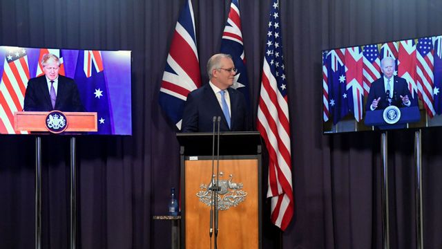 Australia’s Prime Minister Scott Morrison, center, appears on stage with video links to Britain’s Prime Minister Boris Johnson, left, and US President Joe Biden at a joint press conference  announcing the launch of AUKUS, Thursday, Sept. 16, 2021. Photo: Mick Tsikas/AP/TT