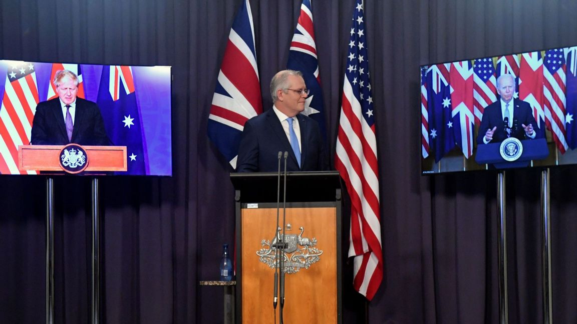 Australia’s Prime Minister Scott Morrison, center, appears on stage with video links to Britain’s Prime Minister Boris Johnson, left, and US President Joe Biden at a joint press conference announcing the launch of AUKUS, Thursday, Sept. 16, 2021. Photo: Mick Tsikas/AP/TT