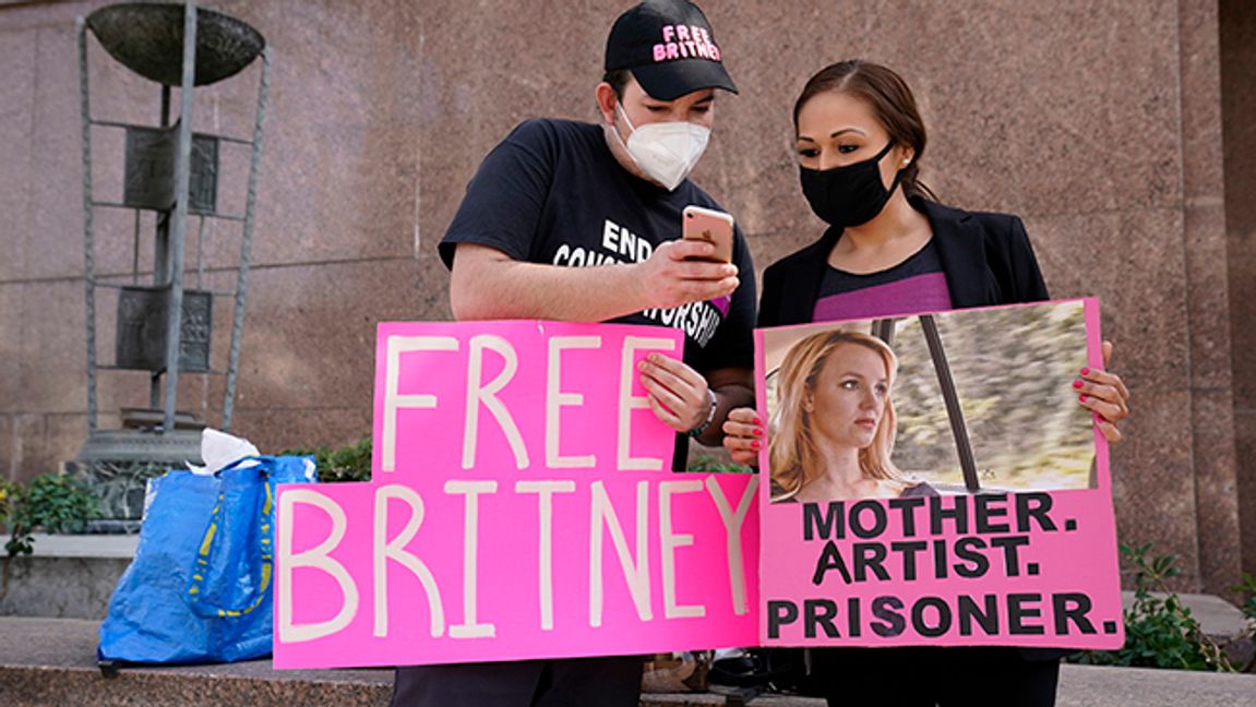 Britney Spears supporters Dustin Strand, left, and Kiki Norberto, both of Phoenix, mingle outside a court hearing concerning the pop singer’s conservatorship at the Stanley Mosk Courthouse, Thursday, Feb. 11, 2021, in Los Angeles. Photo: Chris Pizzello/AP