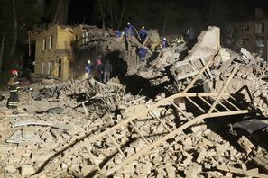 Ukrainsk räddningspersonal söker i rasmassorna natten till torsdag efter en rysk robotattack. Foto: Efrem Lukatsky/AP/TT