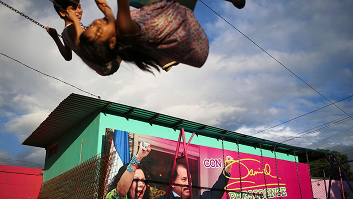 In this Nov. 4, 2016 file photo, children swing in a park next to an election billboard for President Daniel Ortega and his running mate, his wife, Rosario Murillo in Managua, Nicaragua. In June 2021, amid a weekslong clampdown to obliterate nearly every hint of opposition, Ortega ordered the arrest of Hugo Torres, a revered guerrilla in the fight against right-wing dictator Anastasio Somoza. In 1974, Torres had taken a group of top officials hostage, then traded them for the release of imprisoned comrades, among them, Daniel Ortega. Photo: Esteban Felix